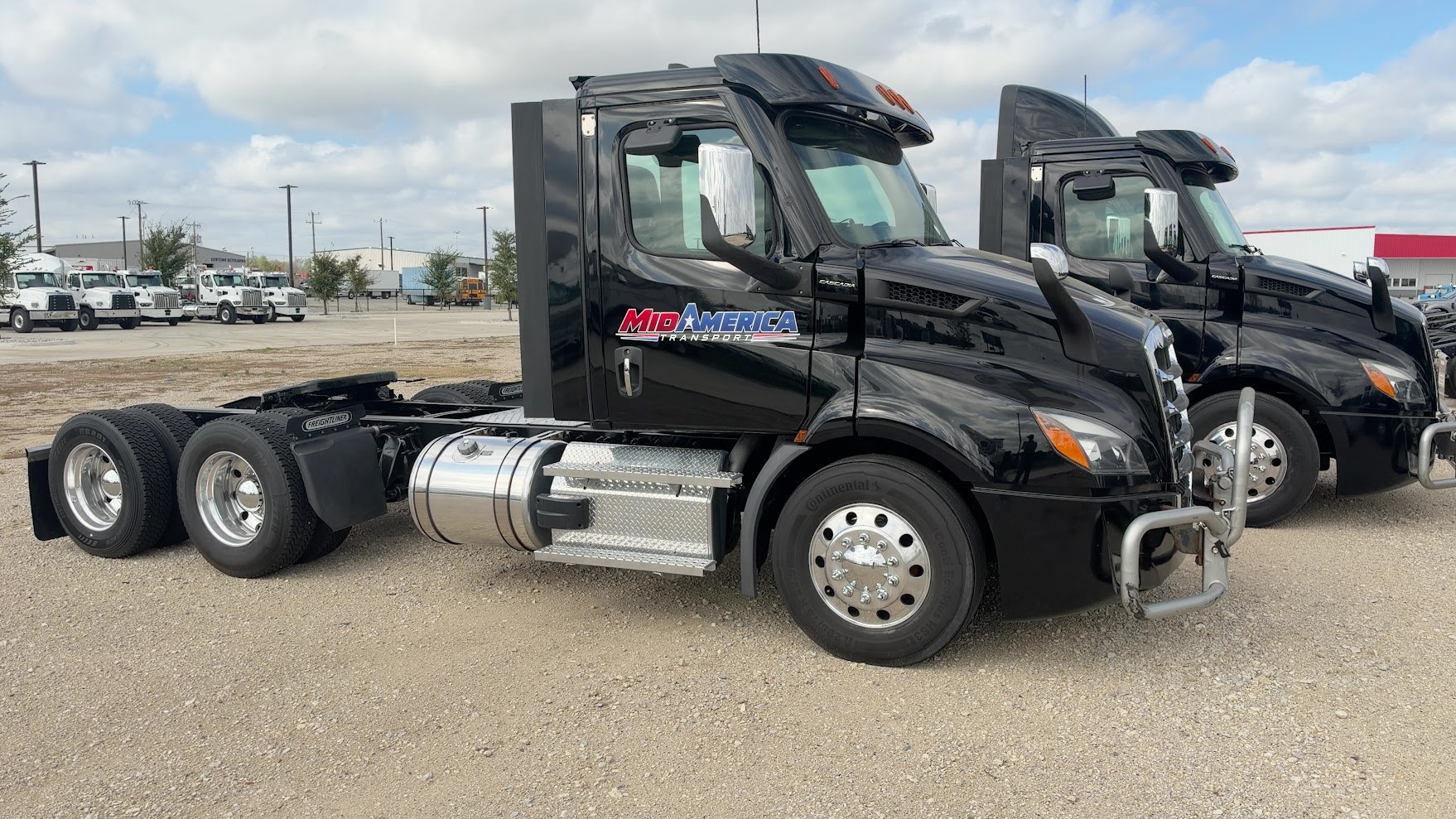 Actual black MidAmerica Freightliner day-cab tractor with branded door